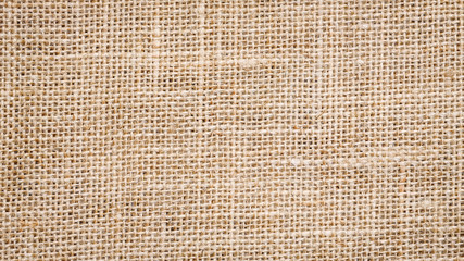 Cotton woven fabric background with flecks of varying colors of beige and brown. with copy space. office desk concept, Jute hessian sackcloth natura / Hessian sackcloth burlap woven texture background