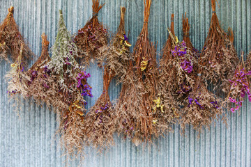 vintage dried bouquet hanging on the wall © kanpisut
