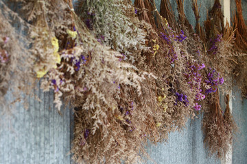 vintage dried bouquet hanging on the wall © kanpisut