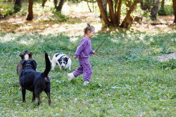 Little girl in a purple suit.