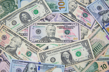 Fototapeta na wymiar Money American dollar bills .Pile of various currencies isolated on white background. Closeup of assorted American banknotes.US currency scattered on the table. America currency.