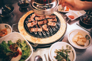 an overhead shot of Korean BBQ gill on a table in a Restaurant 