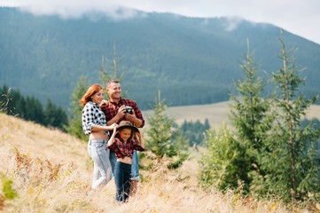 Young family with child resting on a mountain. vacation in the national park