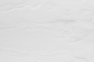 White fluid paint texture with stains and strips as simple abstract background.