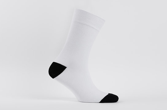 Blank white cotton long sock with black heel on invisible  foot on white background as mock up for advertising, branding, design, side view, template.