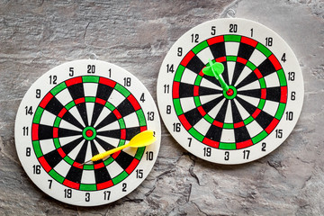 Darts game - simple sport for lesure time. Dartboard and arrows or dart on grey background top view