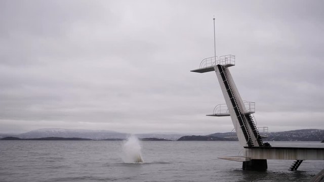 Insane daredevil does a Death Dive from a platforme high above the water