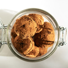 Energy balls in a jar with a yoke lock. Sharp shadows in daylight. Top view