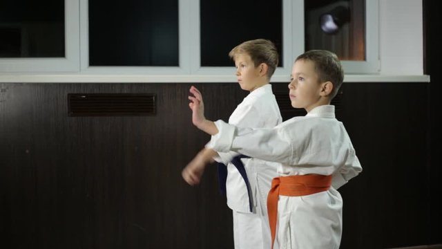 Children practice blow hands in the rack of karate