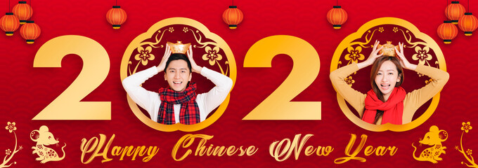 Fototapeta na wymiar asian young couple celebrating for chinese new year. chinese text happy new year 2020