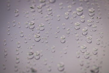 Water drops on glass. Selected focus drop of water on the glass outside the car in the raining day. blurred of drops of rain on glass. Background.