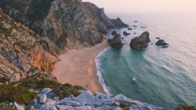 4K scenic view of Praia da Ursa beach in Sintra, Portugal in sunset golden hour light