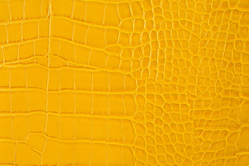 Yellow snakeskin leather background. Elegant texture