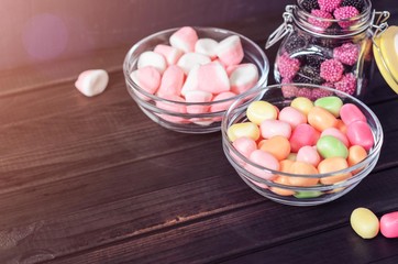 multi-colored candies in a plate, bank and bowls with copy space - 306834440