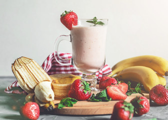 banana and strawberry smoothies with mint on the table, front view - 306834484