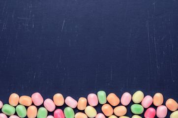 frame of multi-colored candies on a dark background with copy space - 306834495