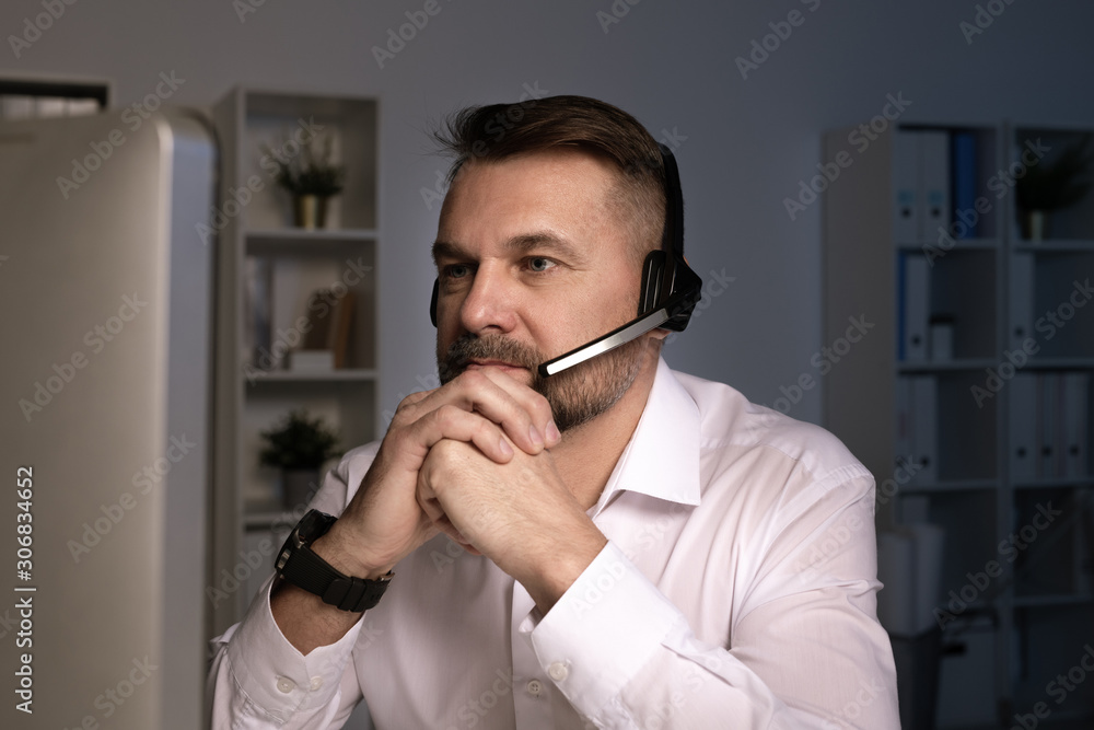 Aufkleber serious telephone operator with headset looking at computer screen