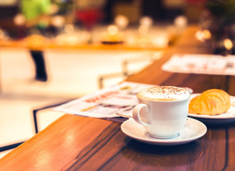 Cup of coffee on the table in the morning.