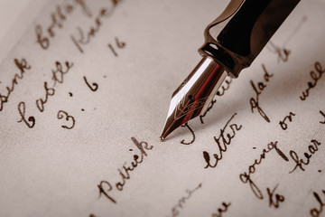 Fountain pen on an ancient handwritten letter. Old story. Retro style.