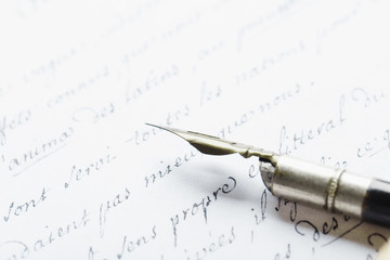 Fountain pen on an ancient handwritten letter. Old story. Retro style.
