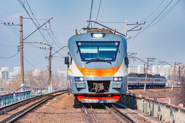 Passenger train moves on city background. Moscow. Russia.