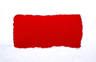A hole in white paper with torn edges with a bright red color paper background inside. Good paper...