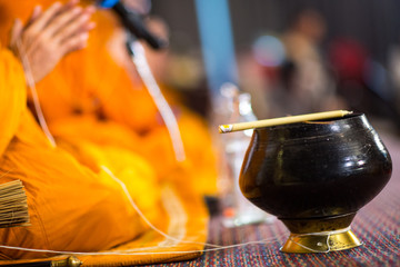 Fototapeta na wymiar Buddha monk hold candlestick above holy water bowl. religion ceremony. Buddhist holy water. image for copy space.