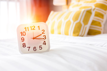 white clock and white bed