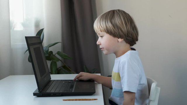 Boy working on a computer, programming, learning or playing