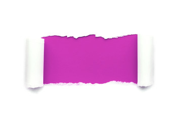 A hole in white paper with torn edges isolated on a white background with a bright violet color paper background inside. Good sharp paper texture.