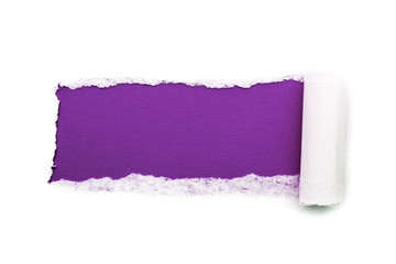 A hole in white paper with torn edges isolated on a white background with a bright violet color paper background inside. Good sharp paper texture.