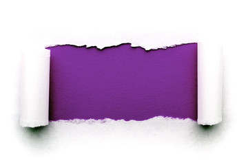 A hole in white paper with torn edges isolated on a white background with a bright violet color paper background inside. Good sharp paper texture.