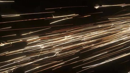 Sparks of welding, shot in a dark space on a black background. You can use this as overlay. Only drag to drop it over your footage and use blending (screen) mode in any editing or animation software. - Powered by Adobe