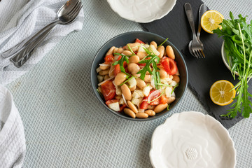 Ready to eat beans salad, healthy protein rich meal with fresh arugula leaves