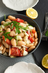 Ready to eat beans salad, healthy protein rich meal with fresh arugula leaves