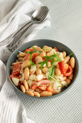 Ready to eat beans salad, healthy protein rich meal with fresh arugula leaves