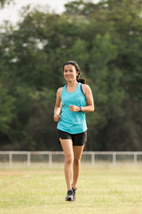 Pretty sporty woman jogging at park