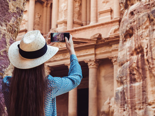 Fashionable woman, exploring the sights of the ancient, fabulous city of Petra in Jordan. Colorful...