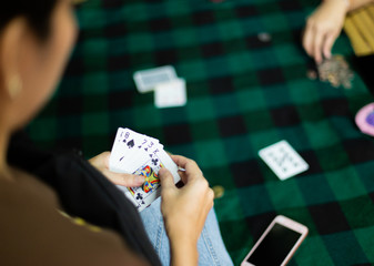 People  playing card and paying coin 