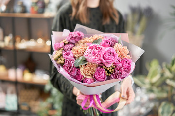 Pink peonies, Sarah Bernhardt and different flowers. European floral shop. Beautiful bouquet in...