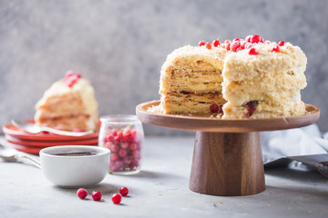 Birthday  creamy layer cake napoleon or chopped cake.  Confectioner decorated with berries on a baking sheet, delicious sweetness. The concept of homemade pastry, cooking pie.