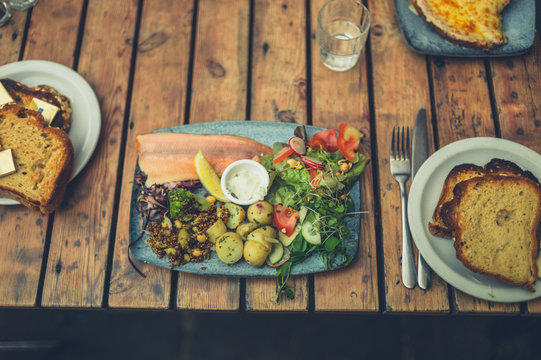 Plate with smoked slamon and salad in cafe