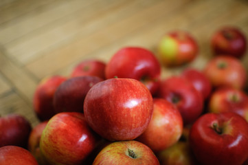Sweet ripe red juicy apples on wooden background, healthy eating and vegetarian lifestyle concepts.