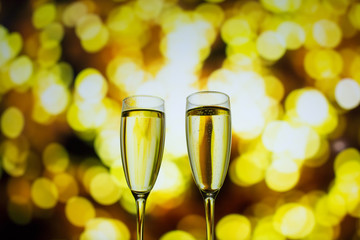 Two glasses of champagne on a bokeh background. Close-up isolated background.