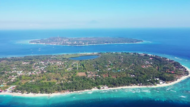 aerial panorama of Gili islands in the blue deep ocean, natural saltwater pool and palms