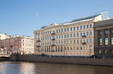Fototapeta na wymiar Modern building on the embankment of the Fontanka river was built on the site of a destroyed old apartment building with the preservation of the historical facade. Saint Petersburg, Russia