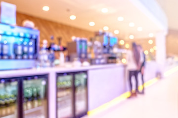 bright cafe restaurant interior blurred background. Wide inside view of hotel dining room ala carte desk with people. Defocused design backdrop