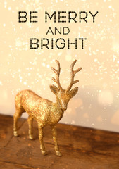 be merry and bright. toy reindeer in golden glitter. new year and Christmas holiday concept. festive beautiful winter composition. with christmas deer. shallow depth, close up, soft selective focus