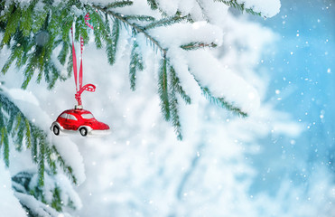 red Christmas car toy and Christmas tree on Snowy background. winter holiday season. Christmas and...