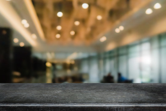 Empty black marble stone table top and blurred coffee shop and restaurent interior background - can used for display or montage your products.